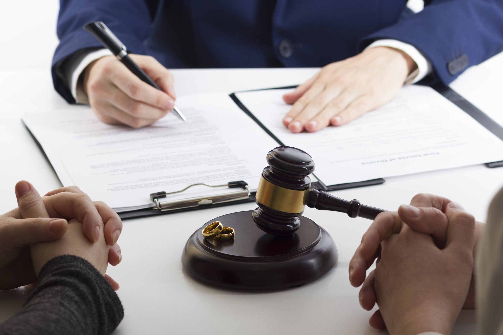 Hands of wife, husband signing decree of divorce. divorce lawyers in collin county tx